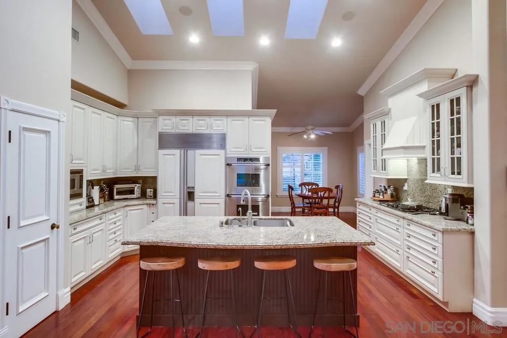 14476 Trailwind Road Poway, CA 92064 - Photo 20 of 61 a kitchen with stainless steel appliances granite countertop a sink a stove counter space and cabinets