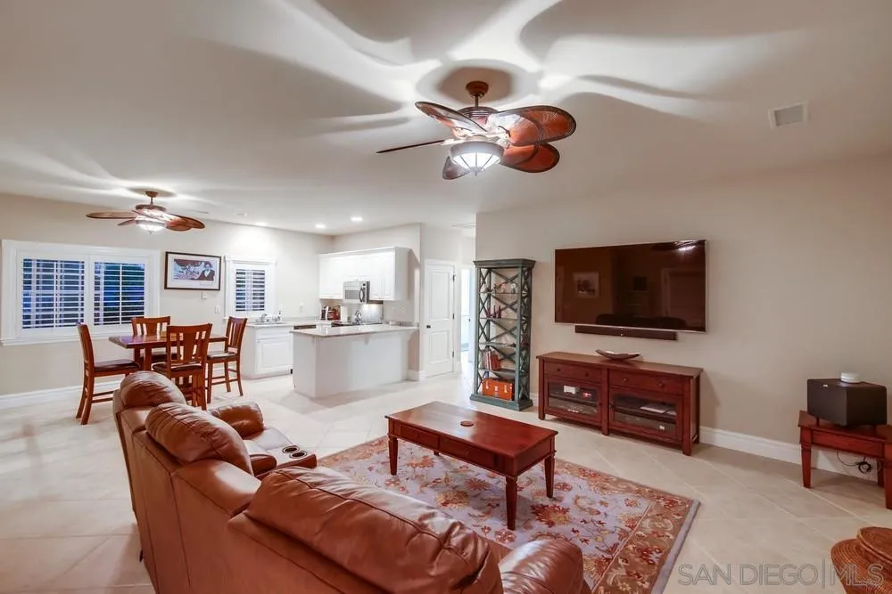 14476 Trailwind Road Poway, CA 92064 - Photo 38 of 61 a living room with furniture a flat screen tv and kitchen view