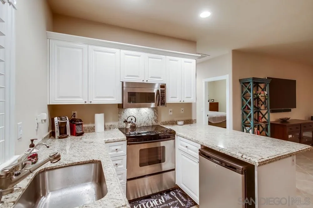 14476 Trailwind Road Poway, CA 92064 - Photo 40 of 61 a kitchen with granite countertop a sink stove and cabinets