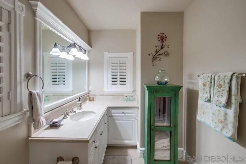 14476 Trailwind Road Poway, CA 92064 - Photo 42 of 61 a bathroom with a sink and a mirror