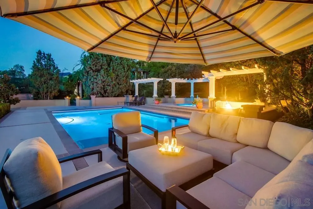 14476 Trailwind Road Poway, CA 92064 - Photo 8 of 61 a view of a patio with couches table and chairs under an umbrella