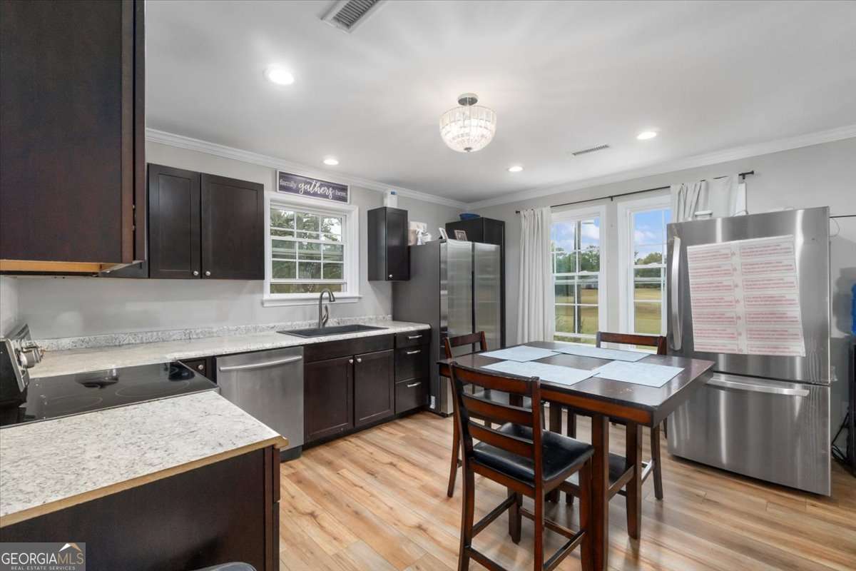 161 Archer Grove Road Athens, GA 30607 - Photo 12 of 56 a kitchen with stainless steel appliances granite countertop table chairs sink refrigerator and microwave