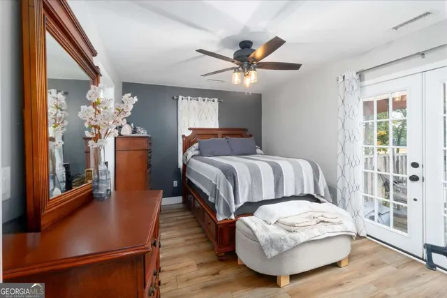 a bedroom with a bed and a mirror on a dresser