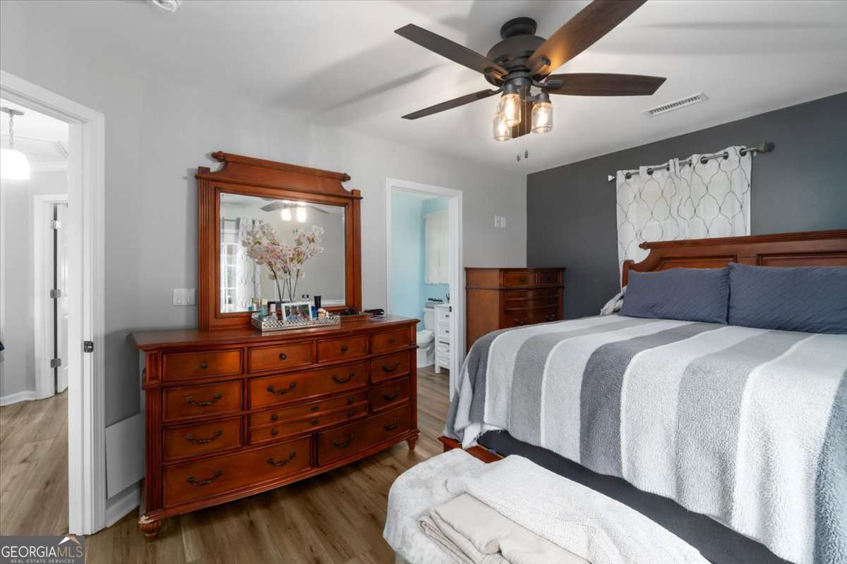 161 Archer Grove Road Athens, GA 30607 - Photo 17 of 56 a bedroom with a bed and a mirror on a dresser