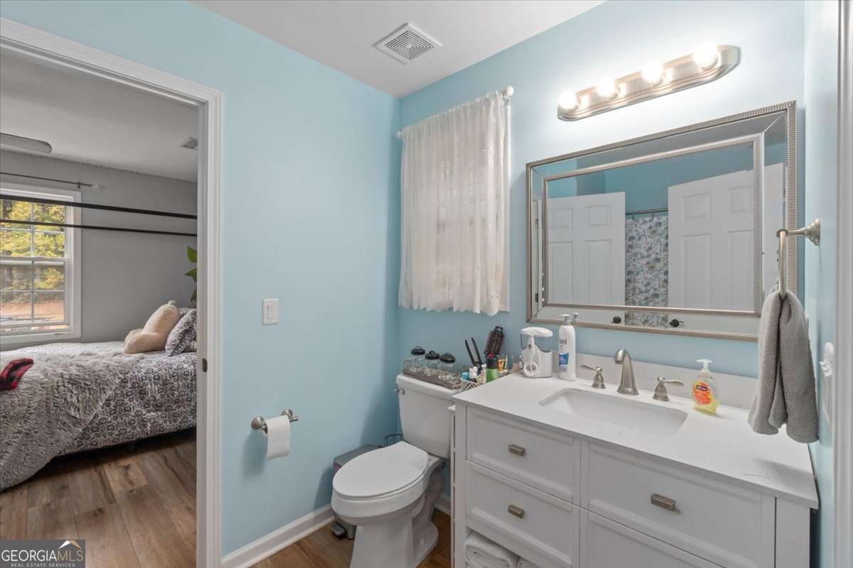 161 Archer Grove Road Athens, GA 30607 - Photo 18 of 56 a en suite bathroom with a granite countertop sink and a mirror