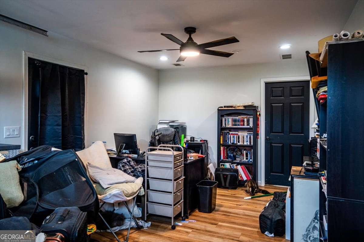 161 Archer Grove Road Athens, GA 30607 - Photo 25 of 56 a living room with furniture a bookshelf and a window