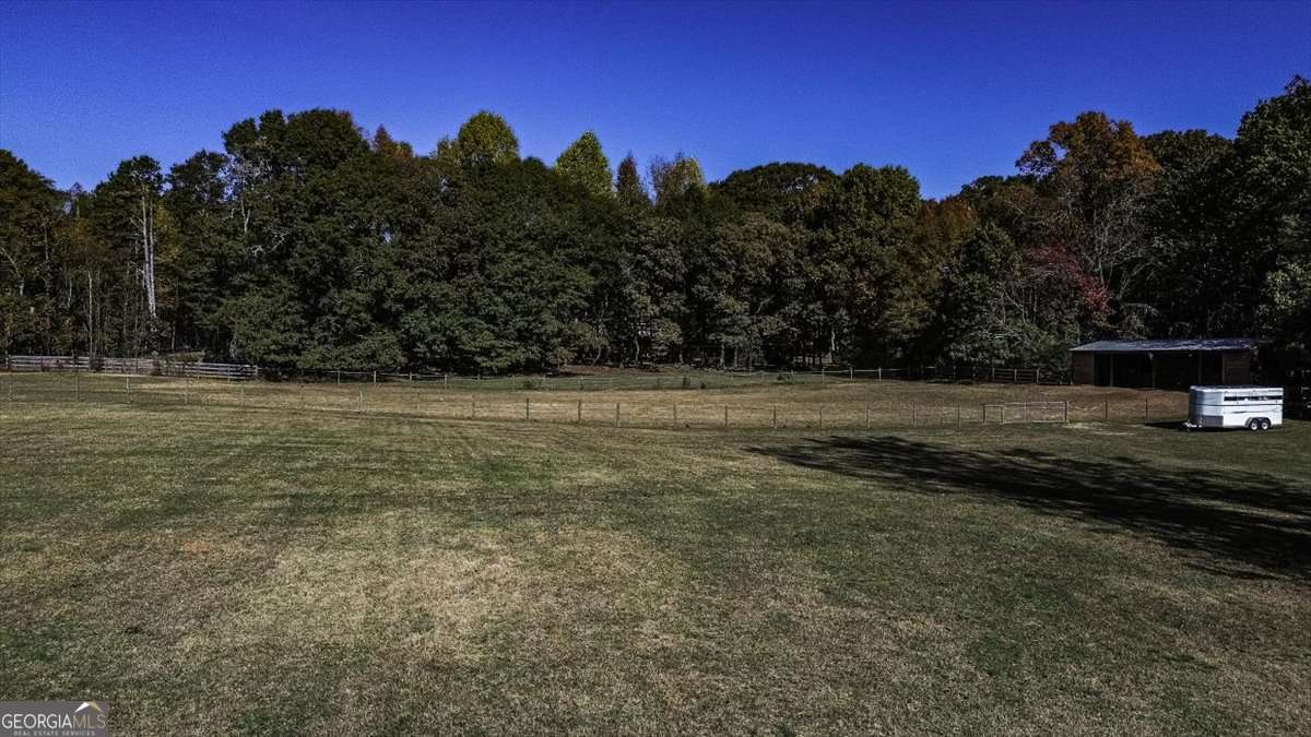 161 Archer Grove Road Athens, GA 30607 - Photo 42 of 56 a view of a field with a tree in the background