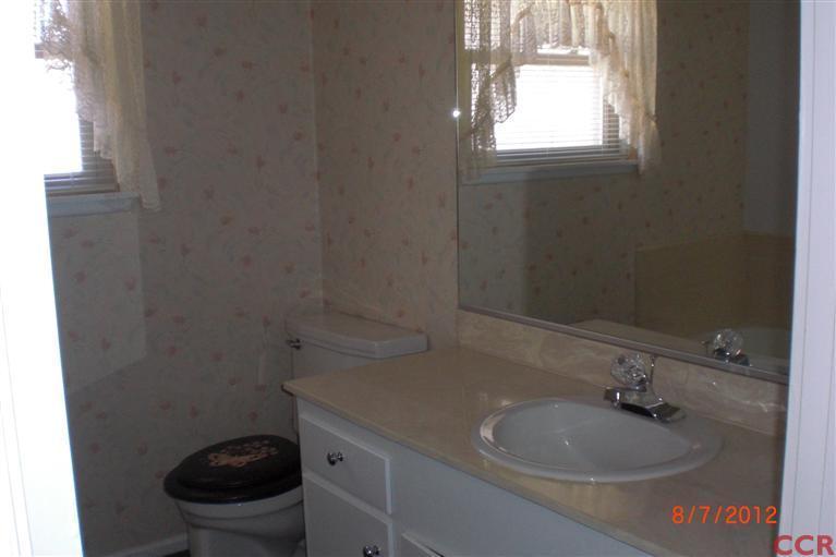 4108 Rigel Avenue Lompoc, CA 93436 - Photo 11 of 16 a bathroom with a sink a toilet and a window