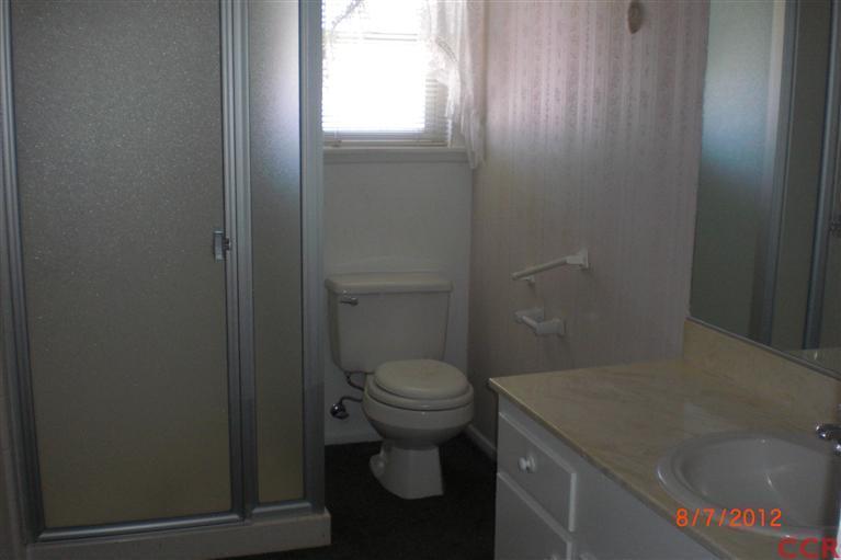 4108 Rigel Avenue Lompoc, CA 93436 - Photo 13 of 16 a bathroom with a granite countertop toilet and a sink