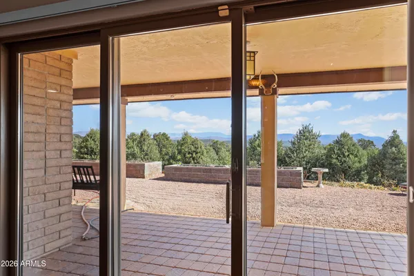 a view of a room with a large window and front door