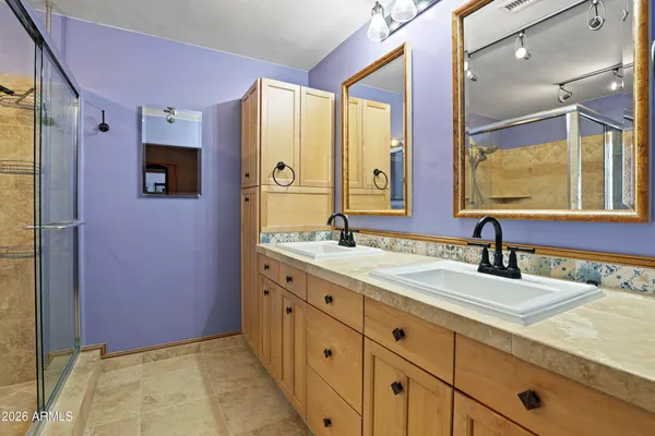 a bathroom with a sink double vanity and a mirror