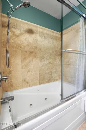 a bathroom with a bathtub and a shower