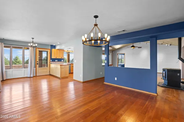 a view of a kitchen with a refrigerator a ceiling fan and wooden floor