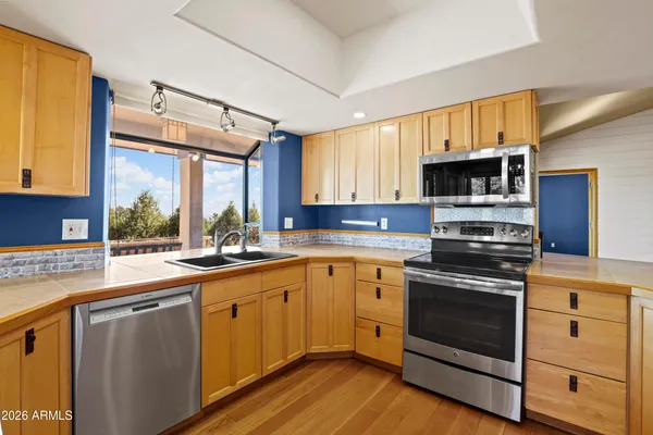 a kitchen with a sink stove and microwave