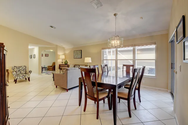 a kitchen with cabinets appliances a sink and a window