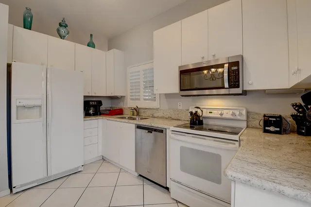 a bathroom with a double vanity sink a mirror and shower