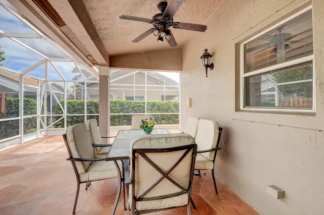 a living room with patio furniture and a chandelier