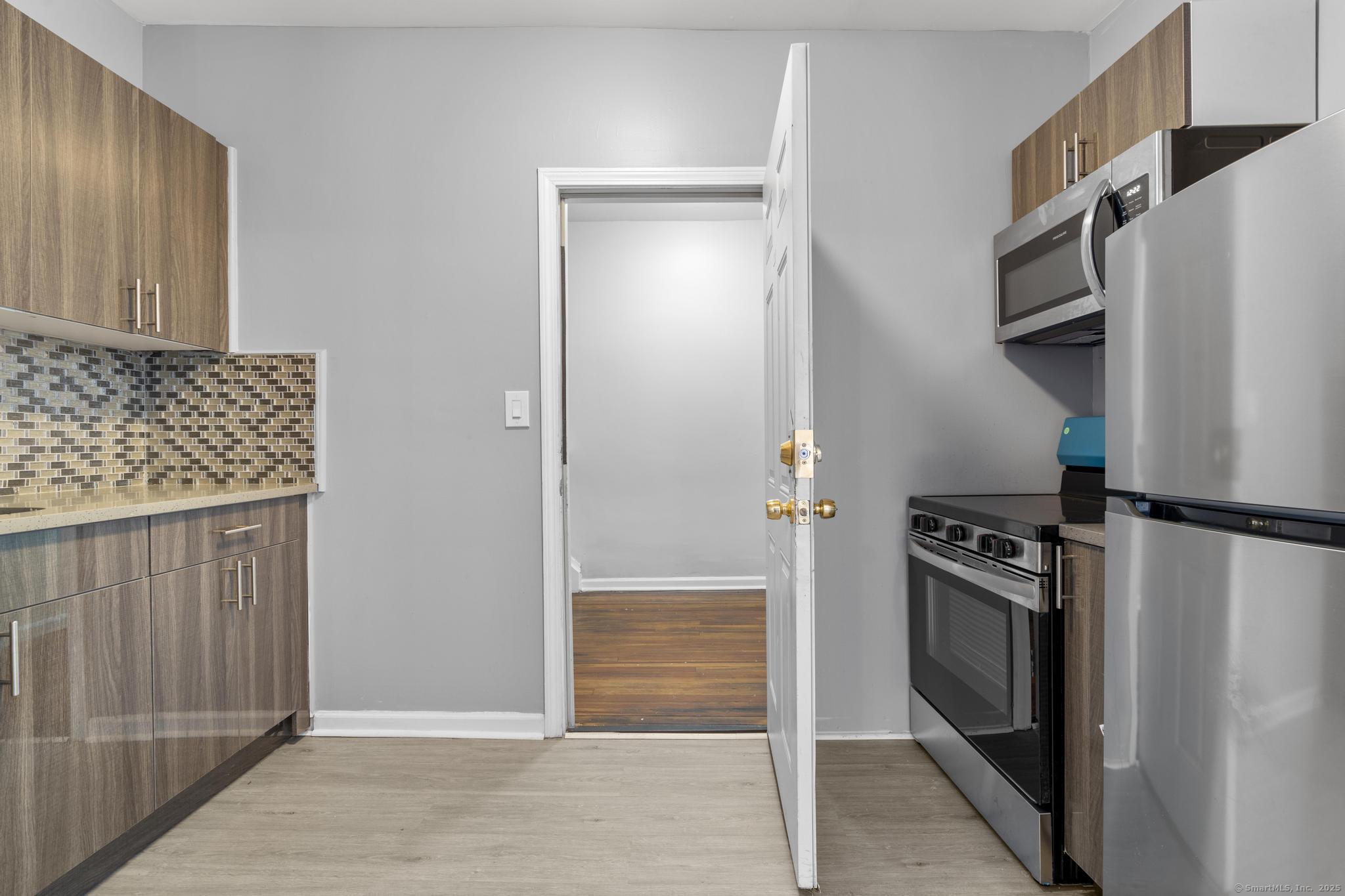 31 Whittier Street Bridgeport, CT 06605 - Photo 19 of 34 a kitchen with stainless steel appliances granite countertop a refrigerator and a stove