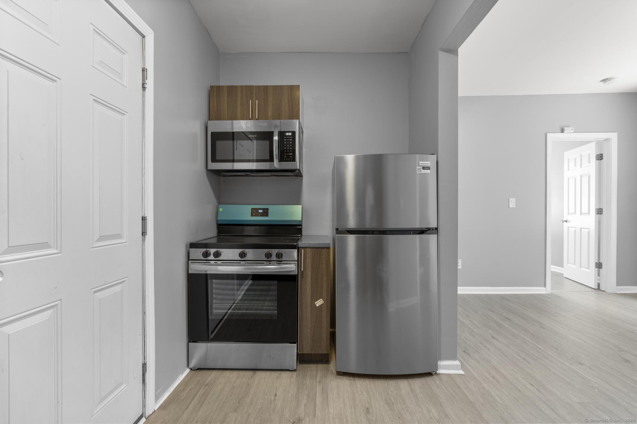 31 Whittier Street Bridgeport, CT 06605 - Photo 20 of 34 a kitchen with a refrigerator stove and wooden floor