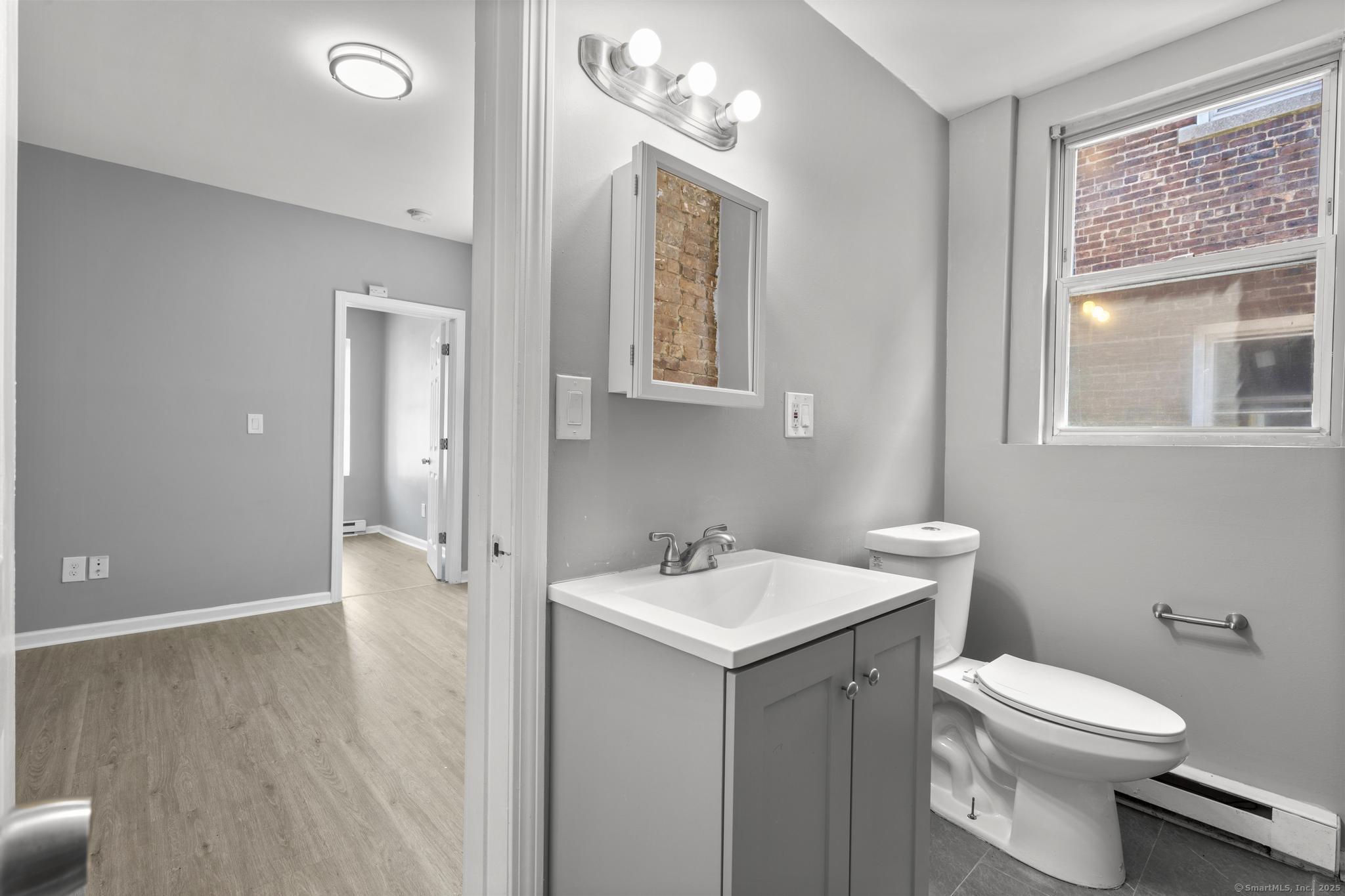 31 Whittier Street Bridgeport, CT 06605 - Photo 23 of 34 a bathroom with a toilet a sink and mirror