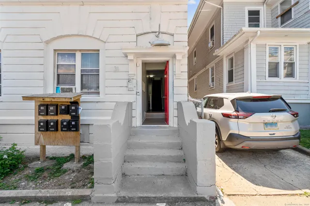 a couple of table and chairs in front of building