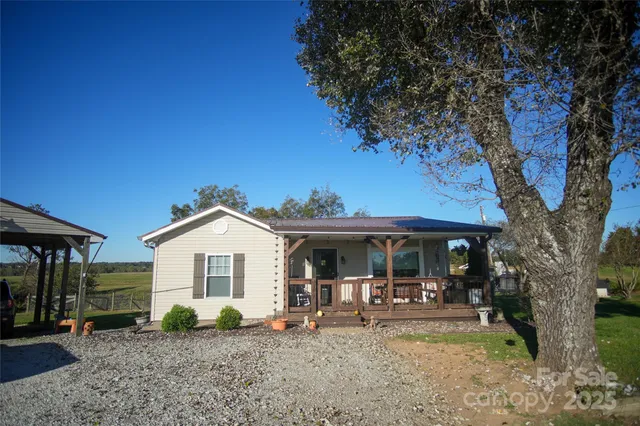 a view of a house with backyard porch and sitting area