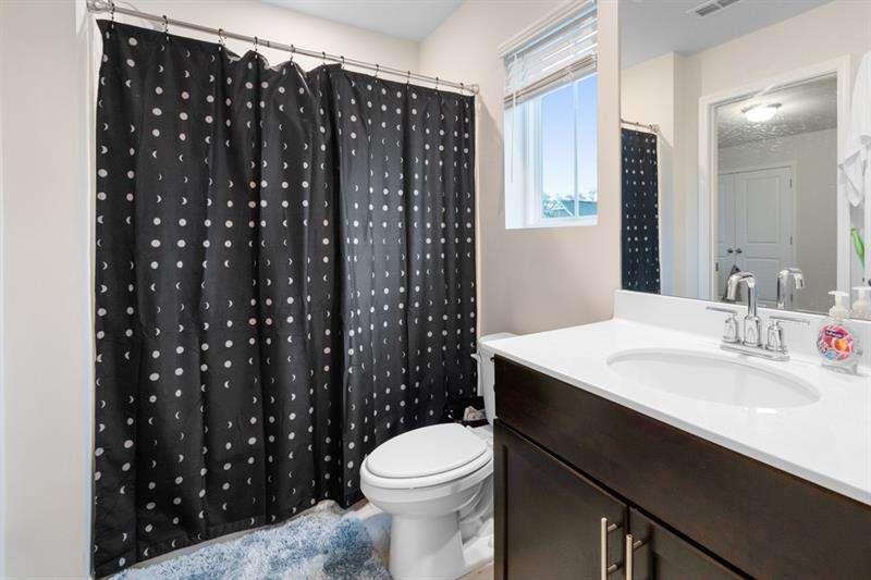 1070 Sunny Lk Drive Lawrenceville, GA 30043 - Photo 19 of 33 a bathroom with a sink a toilet a shower and a mirror