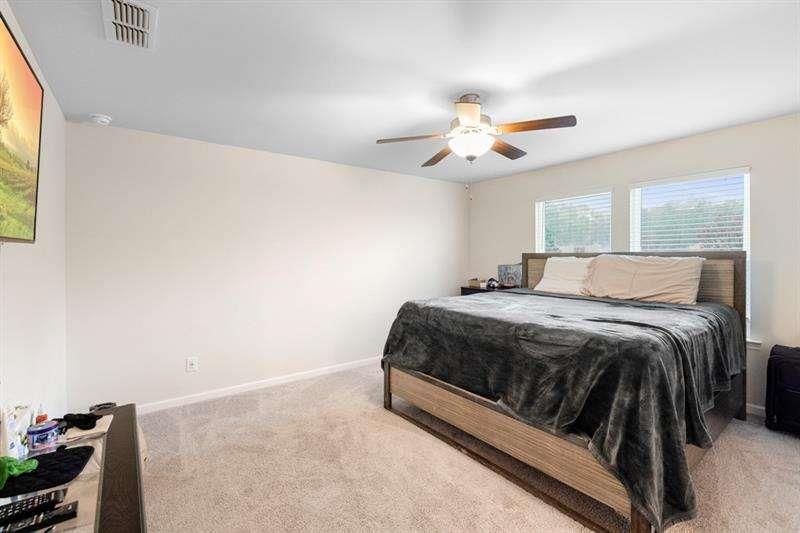 1070 Sunny Lk Drive Lawrenceville, GA 30043 - Photo 24 of 33 a bedroom with a bed and a ceiling fan