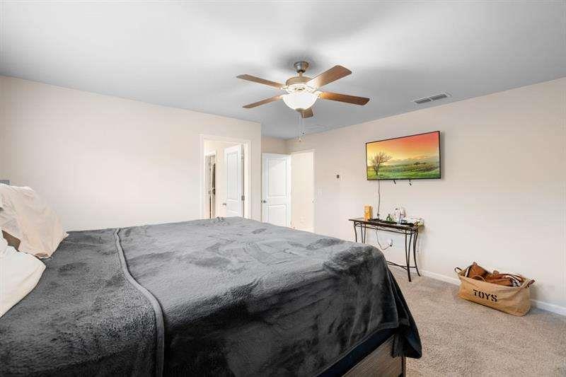 1070 Sunny Lk Drive Lawrenceville, GA 30043 - Photo 27 of 33 a bedroom with a bed and a chandelier
