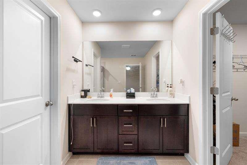1070 Sunny Lk Drive Lawrenceville, GA 30043 - Photo 28 of 33 a bathroom with a double vanity sink and a mirror
