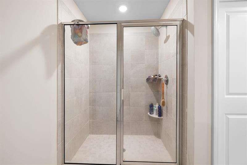 1070 Sunny Lk Drive Lawrenceville, GA 30043 - Photo 29 of 33 a bathroom with a glass shower door