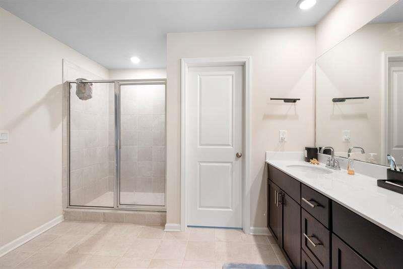 1070 Sunny Lk Drive Lawrenceville, GA 30043 - Photo 30 of 33 a bathroom with a double vanity sink a mirror and a shower