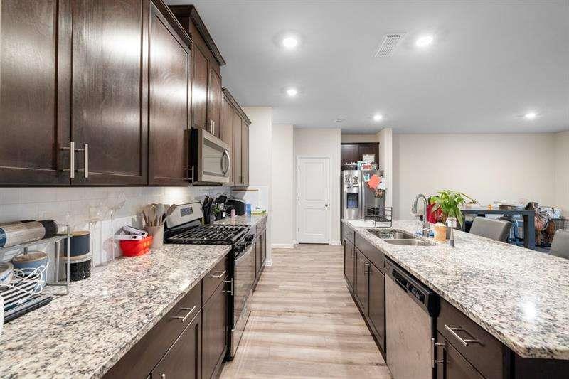 1070 Sunny Lk Drive Lawrenceville, GA 30043 - Photo 10 of 33 a kitchen with granite countertop stainless steel appliances lots of counter top space
