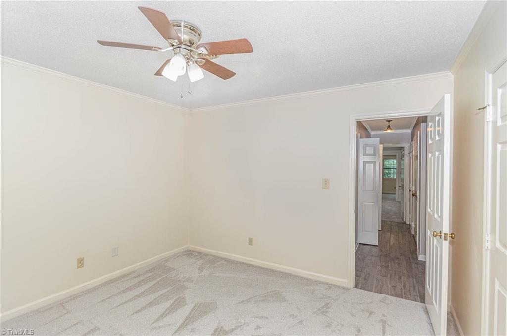 5000 Tower Road, Unit A Greensboro, NC 27410 - Photo 13 of 33 Easy access to the living area from the formal dining room. There is a hallway to one of the bedrooms, too.