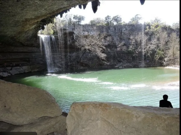 a view of a lake with boats and trees in the background