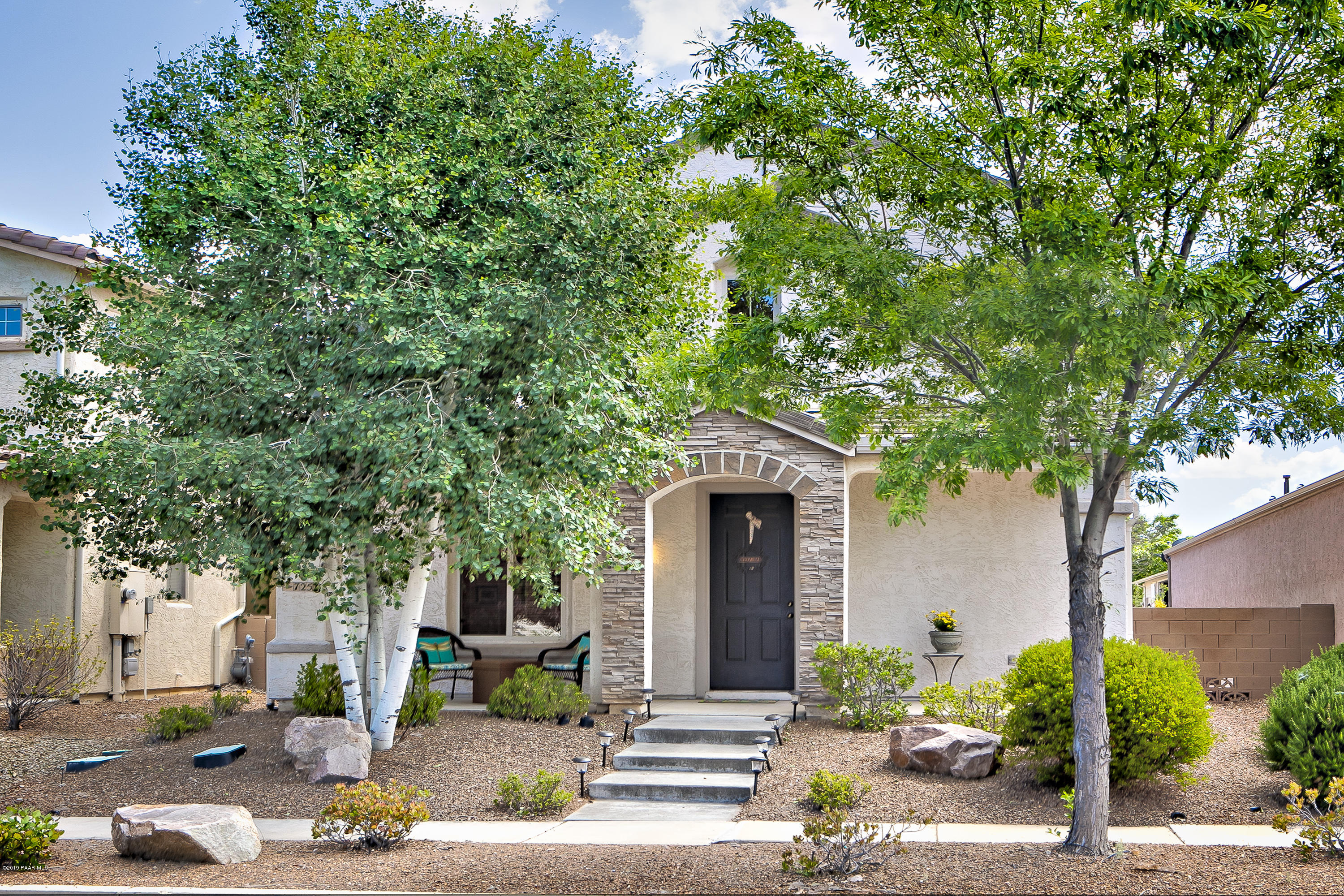 a front view of a house with garden