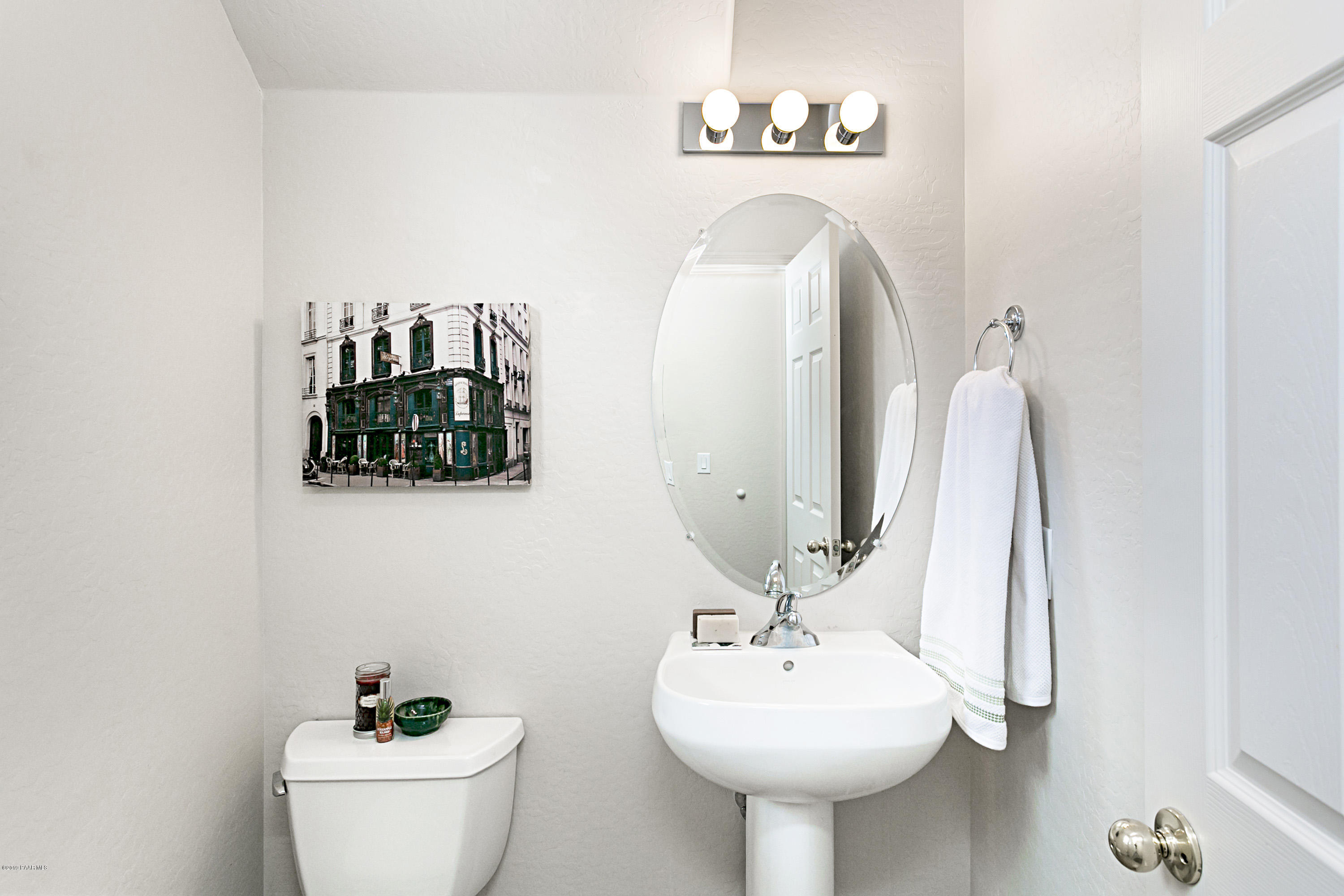 7257 Woolsey Ranch Road Prescott Valley, AZ 86314 - Photo 11 of 31 a bathroom with a toilet sink and mirror
