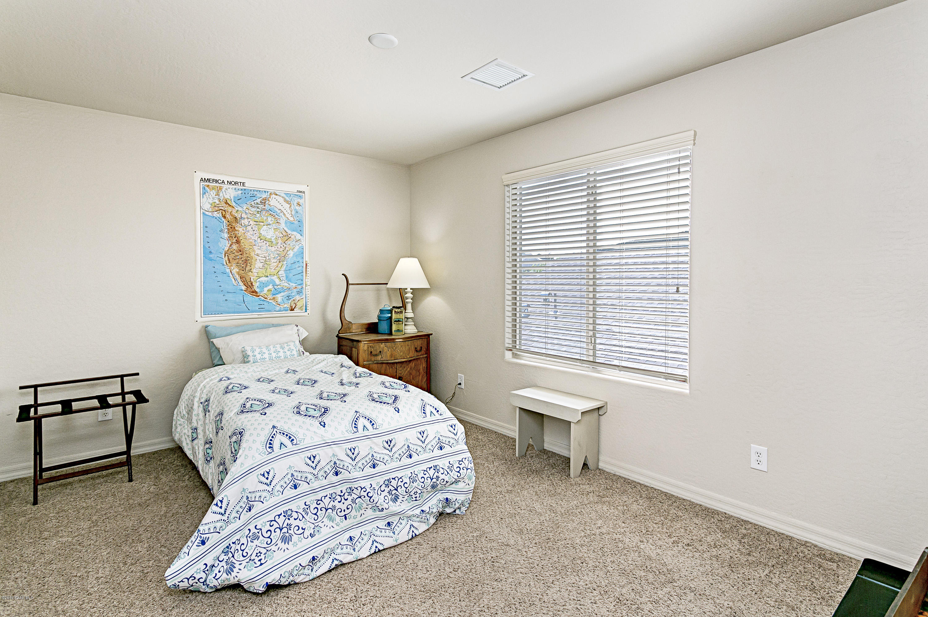 7257 Woolsey Ranch Road Prescott Valley, AZ 86314 - Photo 13 of 31 a bedroom with a bed and a window