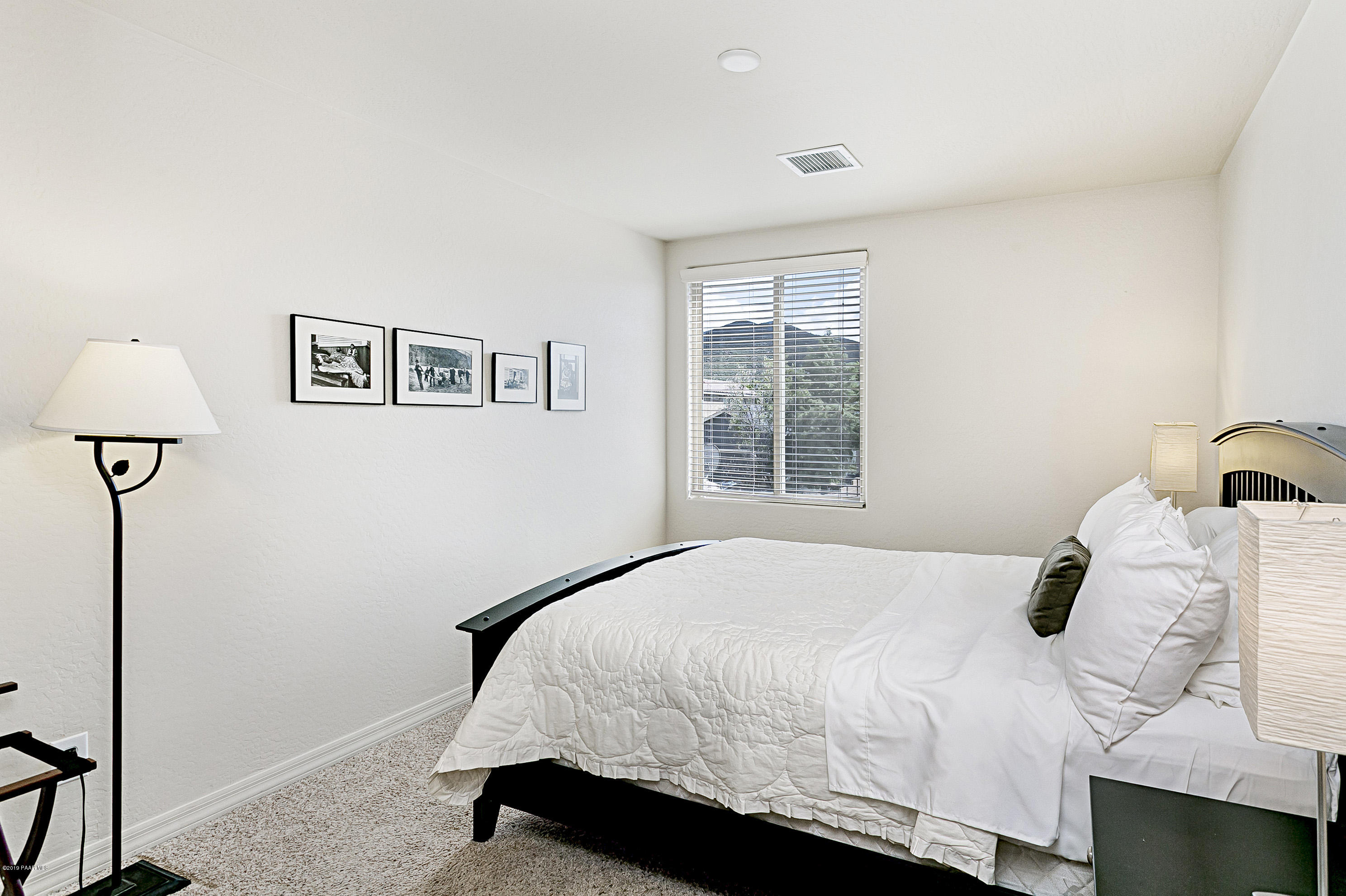 7257 Woolsey Ranch Road Prescott Valley, AZ 86314 - Photo 15 of 31 a bedroom with a bed and a window