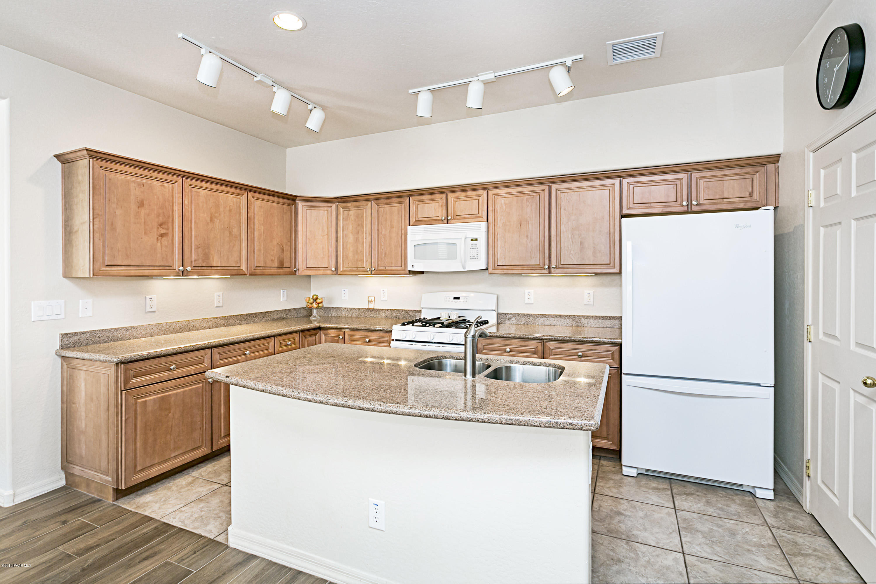 7257 Woolsey Ranch Road Prescott Valley, AZ 86314 - Photo 6 of 31 a kitchen with a sink a stove and refrigerator