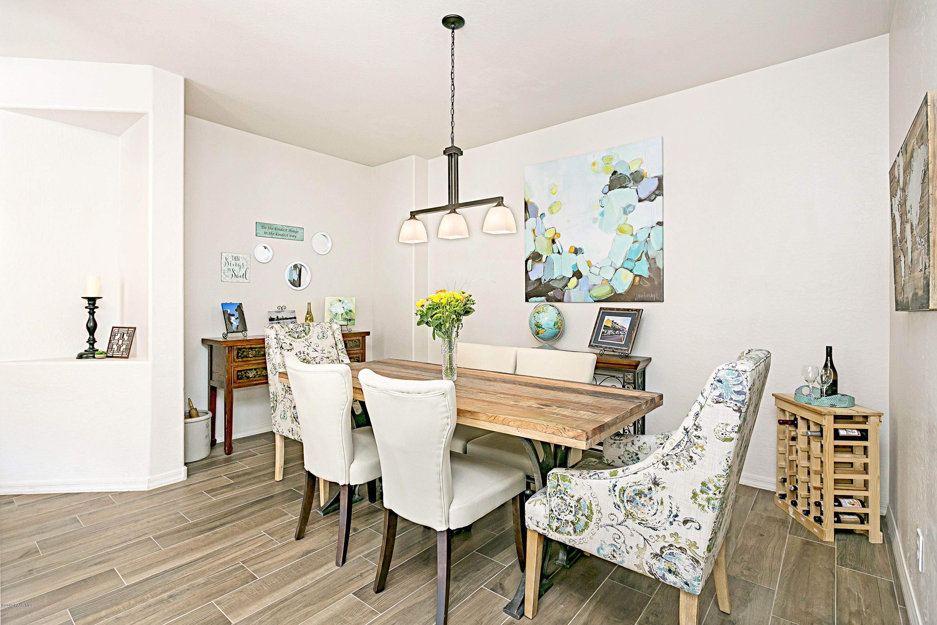 7257 Woolsey Ranch Road Prescott Valley, AZ 86314 - Photo 7 of 31 a view of a dining room with furniture wooden floor and kitchen
