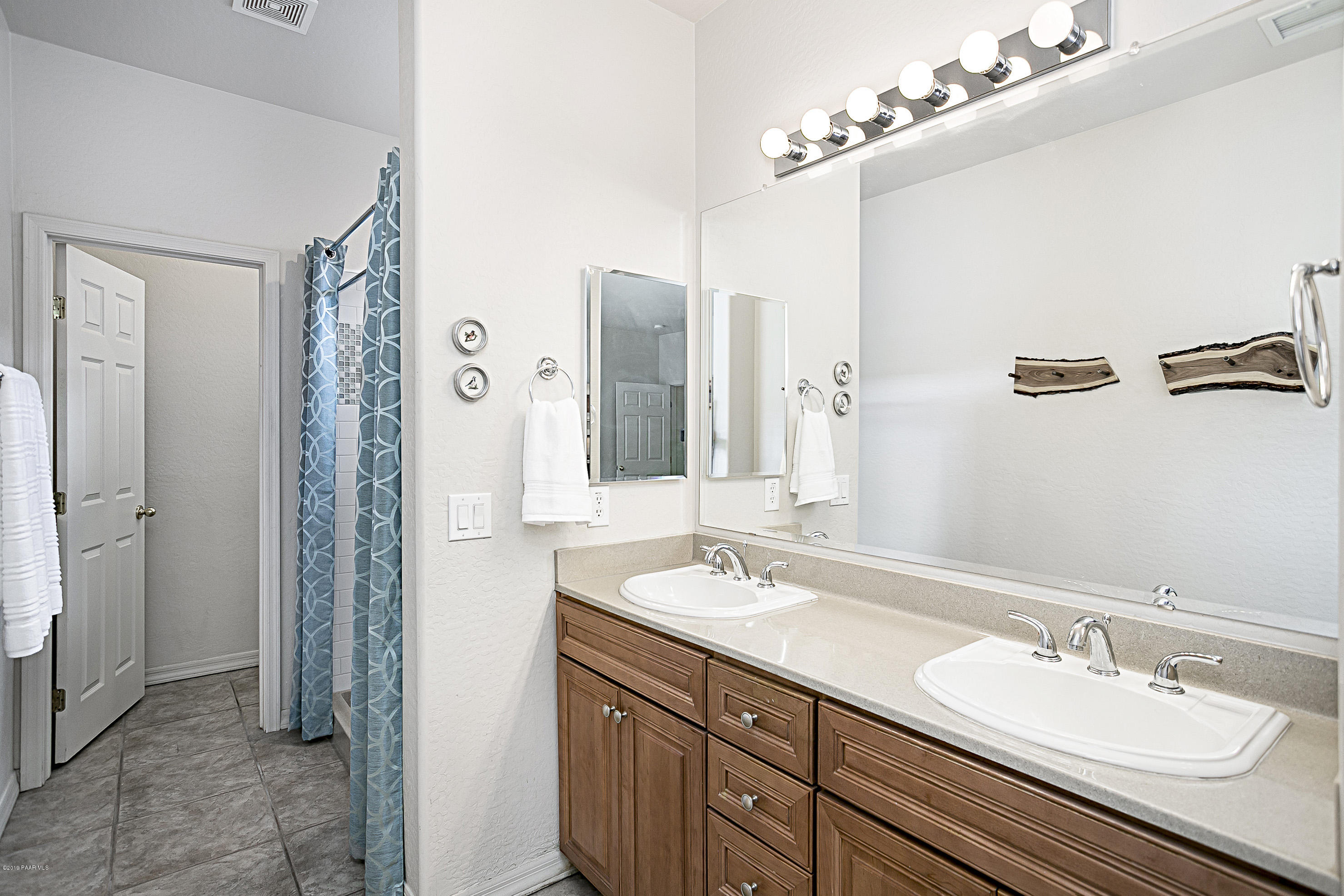7257 Woolsey Ranch Road Prescott Valley, AZ 86314 - Photo 10 of 31 a bathroom with a double vanity sink mirror and shower