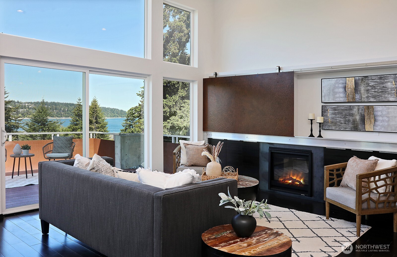 1649 Stewart Road Freeland, WA 98249 - Photo 16 of 40 a living room with furniture a large window and a fireplace