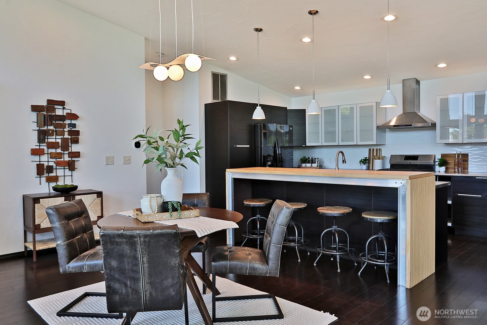 1649 Stewart Road Freeland, WA 98249 - Photo 22 of 40 a dining room filled chandelier and wooden floor