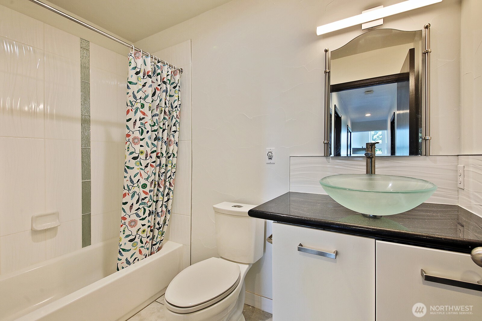 1649 Stewart Road Freeland, WA 98249 - Photo 31 of 40 a bathroom with a granite countertop sink toilet a mirror a vanity and shower
