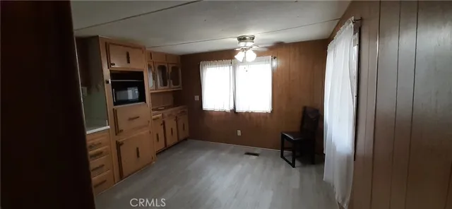 a room with wooden floor and outdoor view