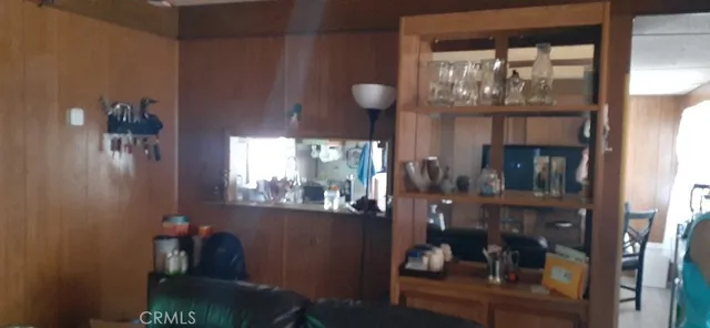 a view of a livingroom with wooden floor and brick walls