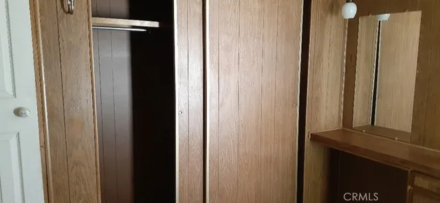 a view of a room with wooden floor and a window