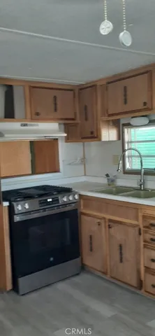 a kitchen with white cabinets and a stove top oven
