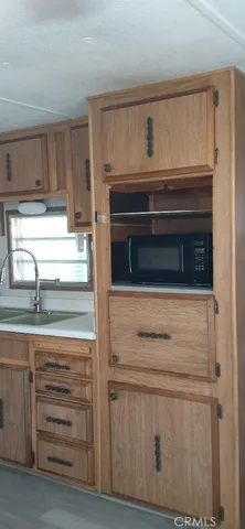 a kitchen with a stove and a wooden floor